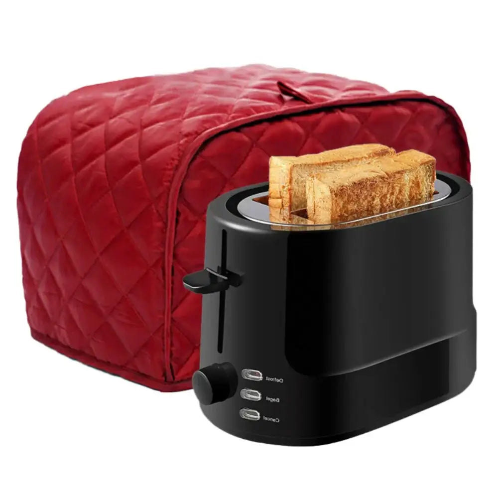 Black 2 slice toaster with toasted bread inside covered by a red quilted fabric slice toaster cover protector