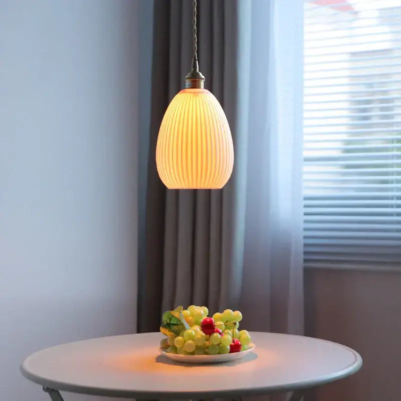 Warm-toned ribbed glass pendant lamp with brass-finished fixture complementing decorbites ceramic led pendant design