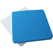 Blue square foam cake shaping mat with evenly spaced circular indentations for precise cake shaping in the kitchen