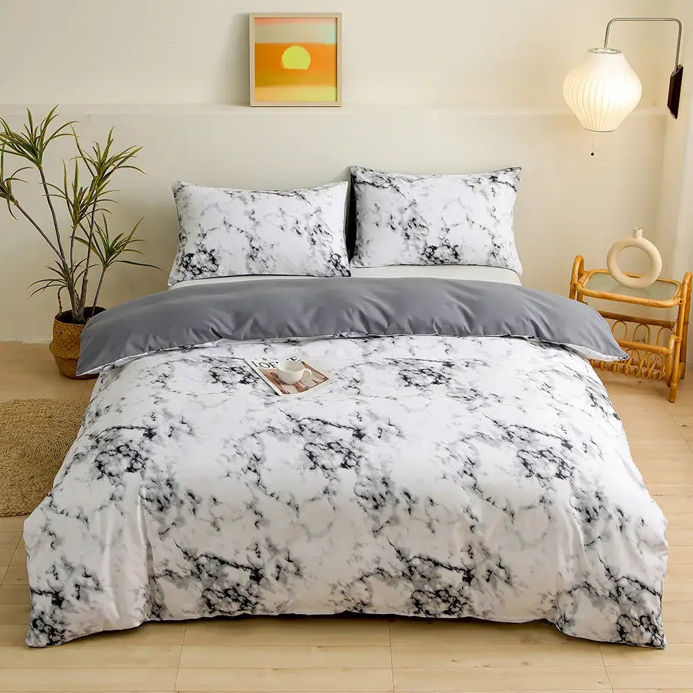 Blue starry sky duvet cover set featuring a white and black marble-patterned duvet cover with a solid gray comforter