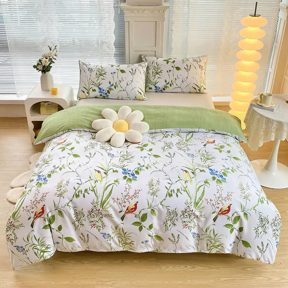 White duvet cover set with vibrant botanical print of green leaves blue flowers and red birds for bedroom bedding