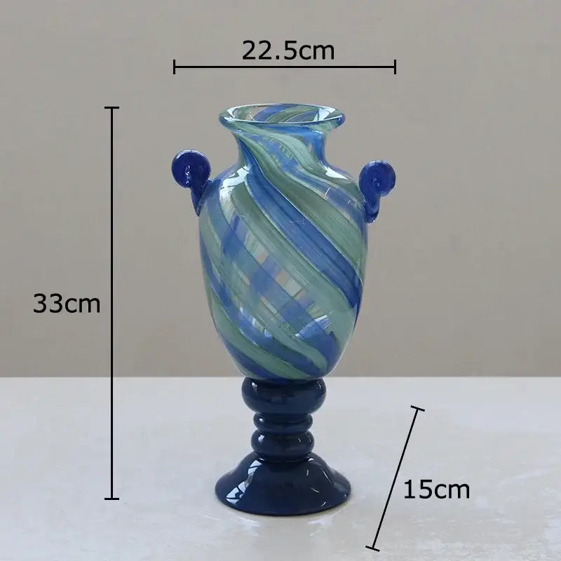 A tall blue stripe glass swirl vase with dark blue handles and pedestal base for living room hydroponic plant decorbites