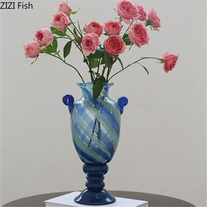 A vibrant blue stripe glass vase with green stripes, classic urn shape, elegant handles, and a sturdy pedestal base