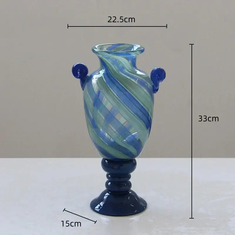 A tall decorbites blue striped transparent glass vase with swirling blue and green patterns for living room decor