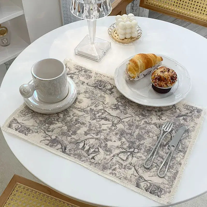 Beige decorbites cotton linen meal mat featuring vintage black and white animal illustration with frayed edges