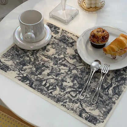 Beige cotton linen meal mat with black and white forest scene print and frayed edges from decorbites cotton linen collection