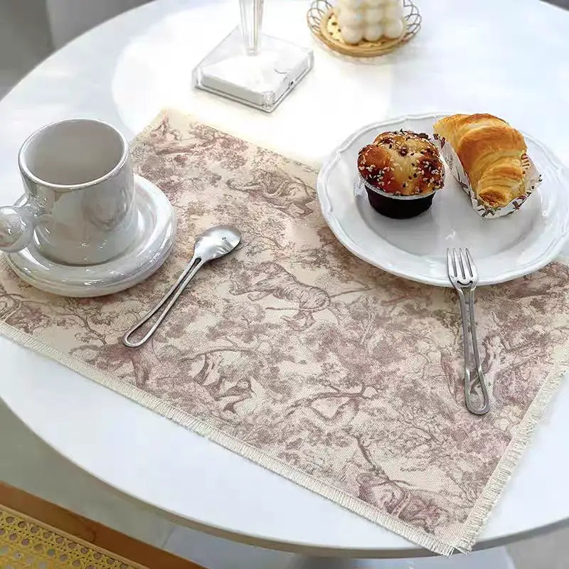 Beige decorbites cotton linen meal mat with subtle brown vintage animal and tree pattern and frayed edges