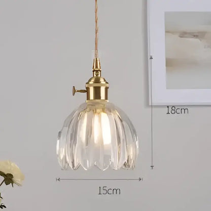 A vintage-style pendant light with a brass fixture and clear faceted glass shade by decorbites pendant lights