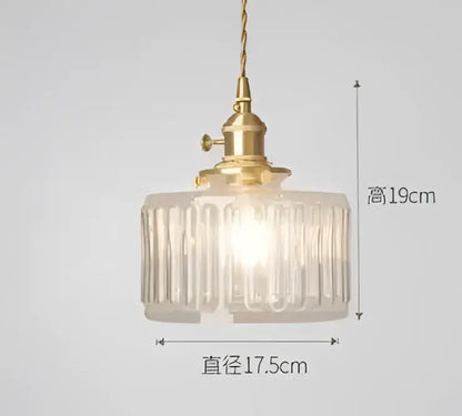A vintage-style decorbites pendant light with a brass fixture and blue translucent ribbed glass shade for bedroom decor
