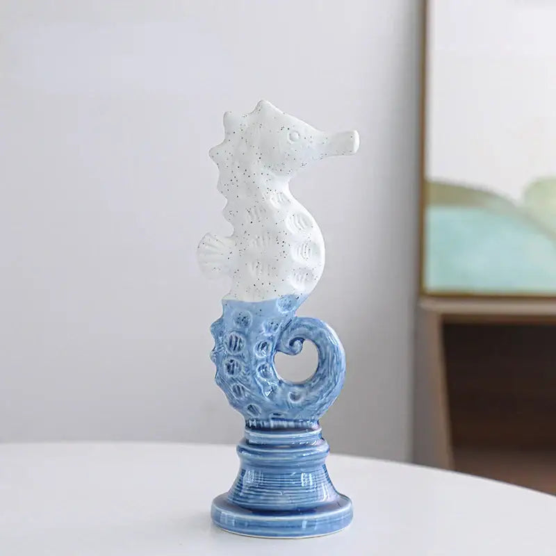 Blue and white cartoon seahorse ceramic statue with intricate patterns on a matching pedestal base for living room decorbites