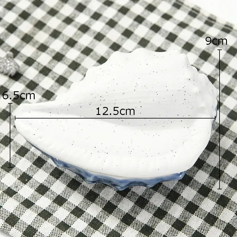 White ceramic marine life clamshell tray with speckled finish and blue glazed rim for decorbites ceramic marine decor