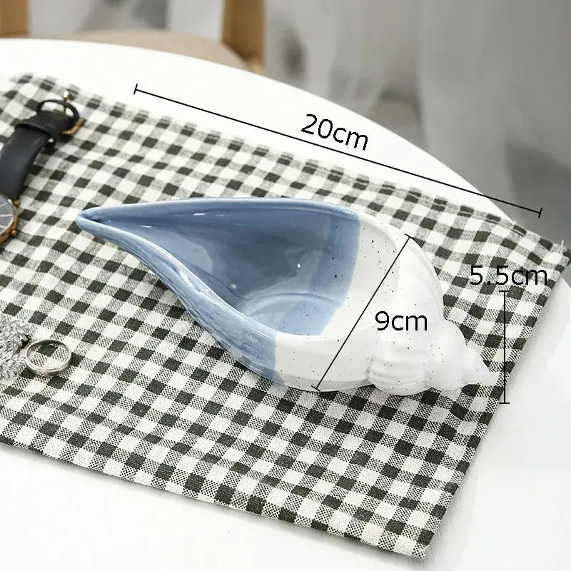 A blue and white ceramic marine life clamshell tray with glossy glaze and subtle exterior speckles for decorbites ceramic marine decor
