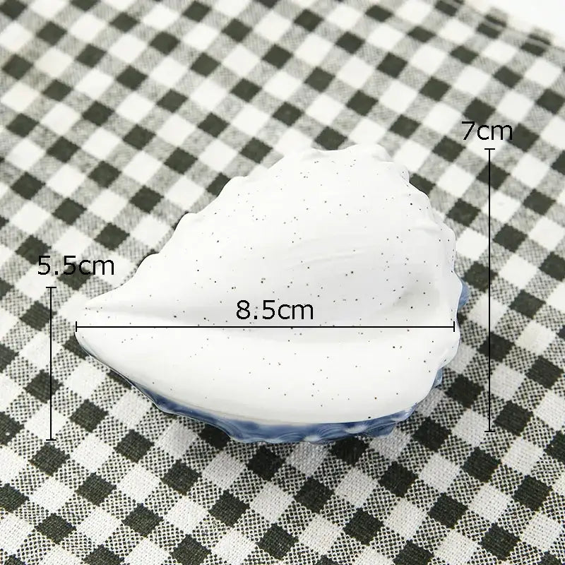 White ceramic marine life clamshell tray with speckled glaze and blue rim decorbites ceramic marine bedroom decor
