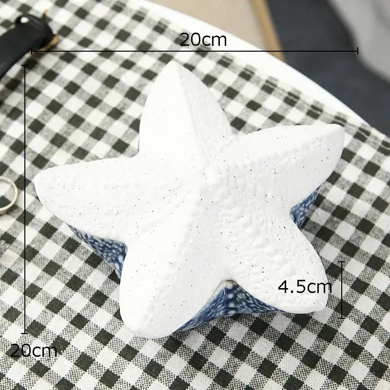 White star-shaped decorbites ceramic marine life box with textured surface and blue patterned ceramic marine life base