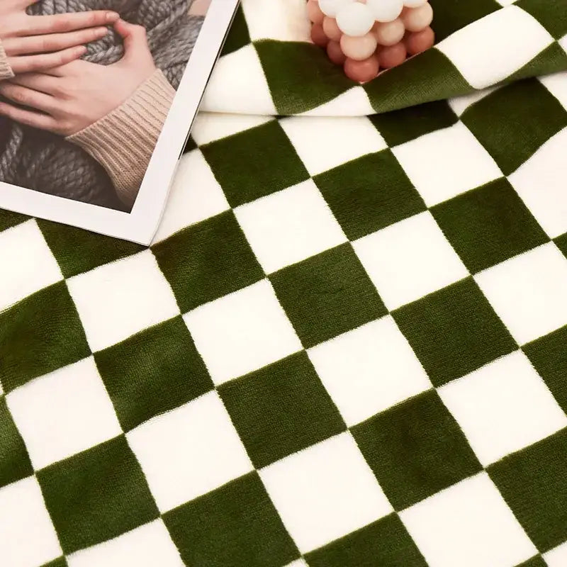 A plush green and white checkered double layer lamb wool checkered blanket with a soft velvety texture for bedrooms