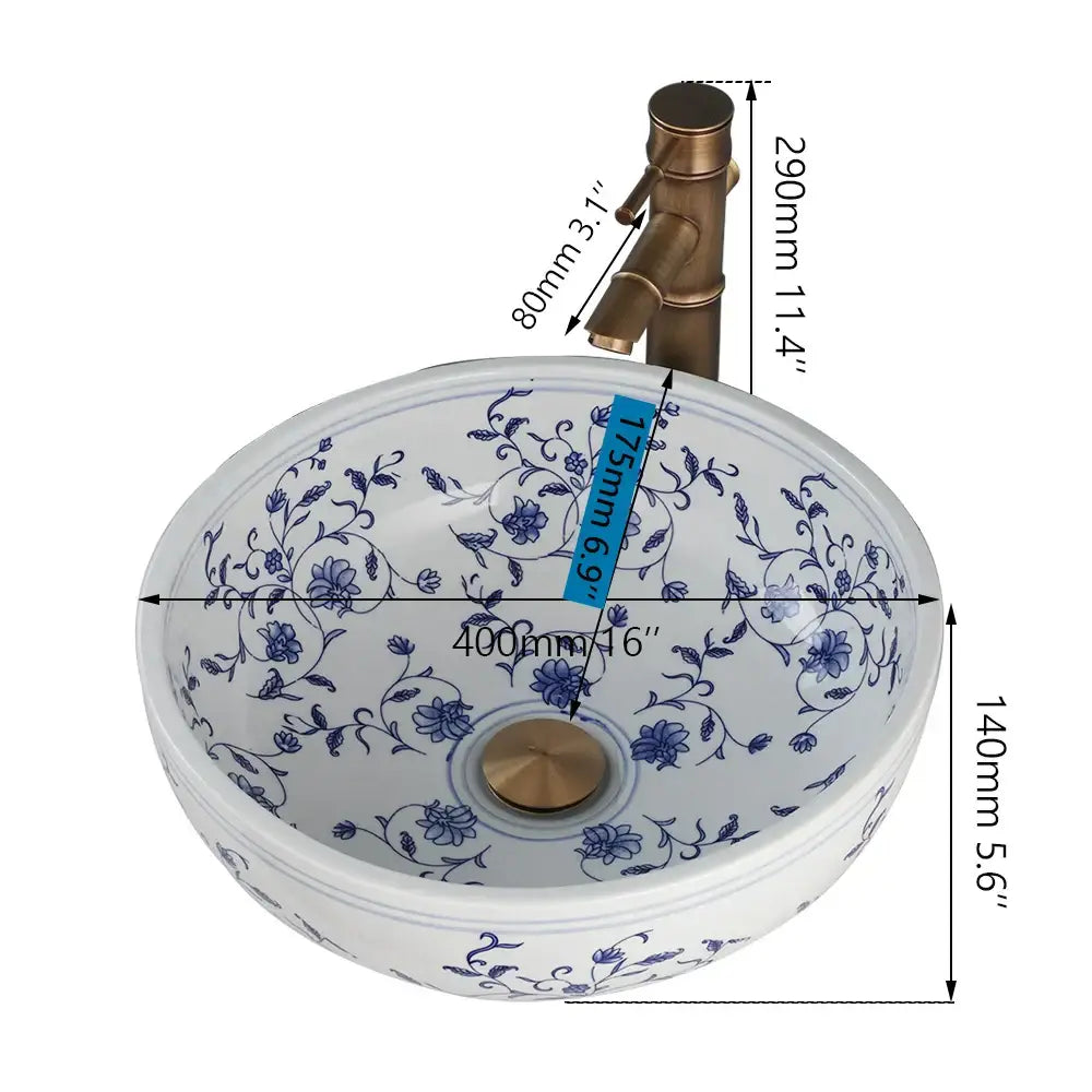 White porcelain basin set with blue floral patterns and brass pop drain for elegant bathroom sink use