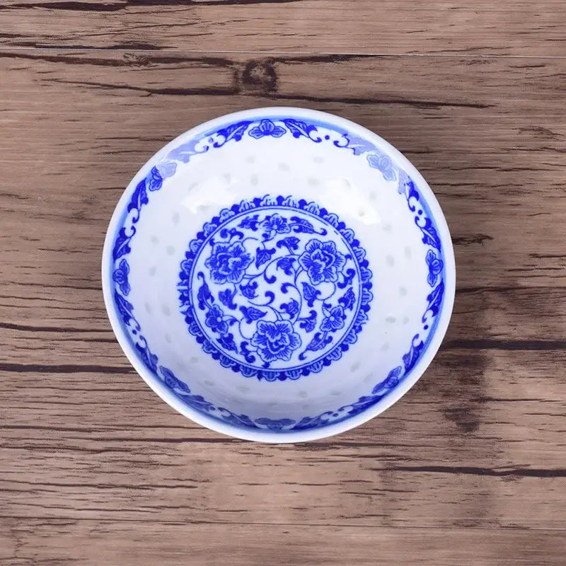 White porcelain dragon pattern dish set bowl with intricate blue floral designs and perforated decorative rim