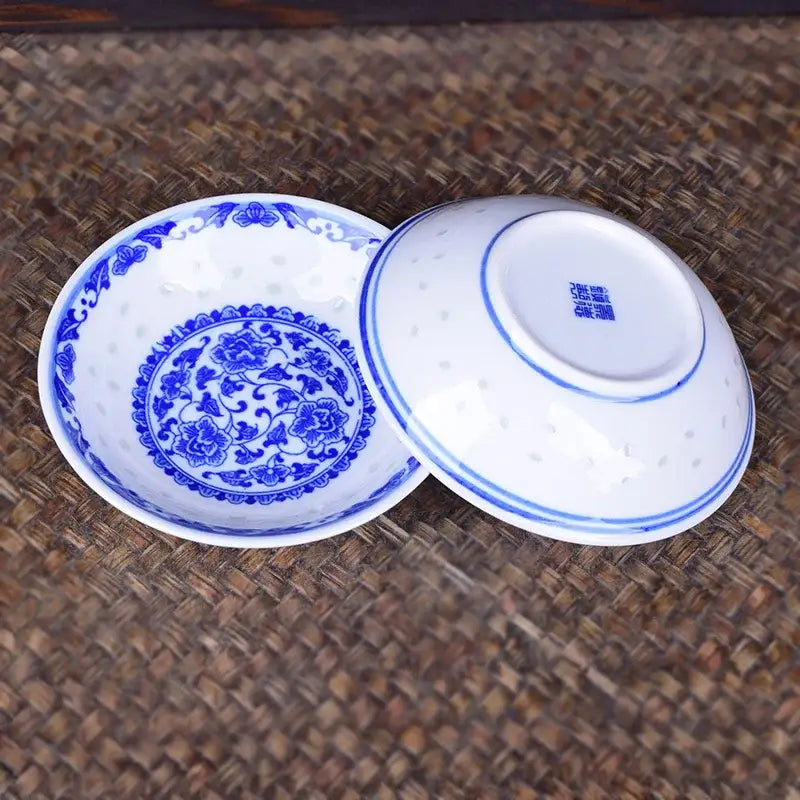 A delicate white porcelain dragon dish set bowl with intricate blue floral patterns and a matching lid