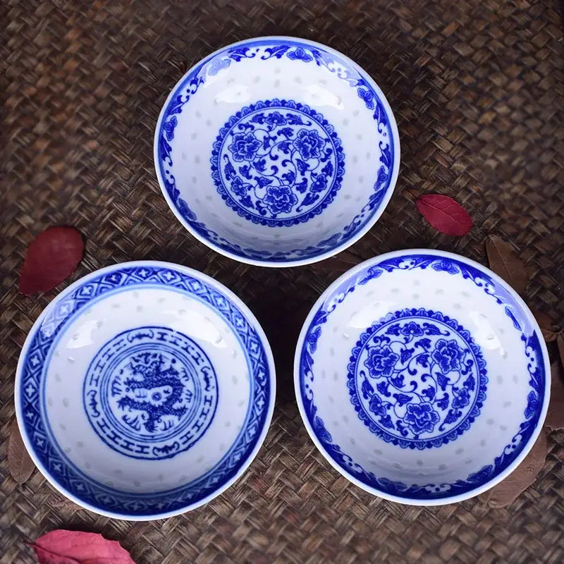 Three white porcelain dragon pattern bowls with intricate blue floral and dragon motifs in a dish set
