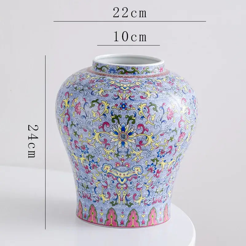A decorative blue white porcelain floral vase with intricate pink yellow green and gold patterns for living room decor