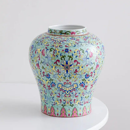 A vibrant turquoise blue white porcelain floral vase with intricate pink yellow and green scrollwork for living room decorbites decor