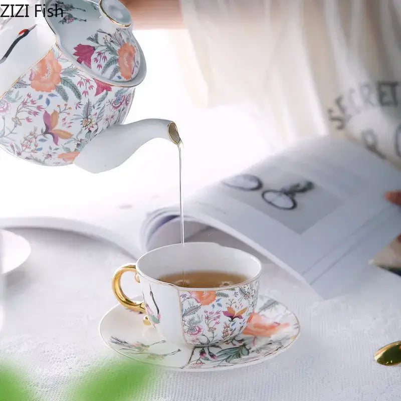 Delicate blue white porcelain coffee mug and teacup set with vibrant floral pattern and gold gilded trim by decorbites