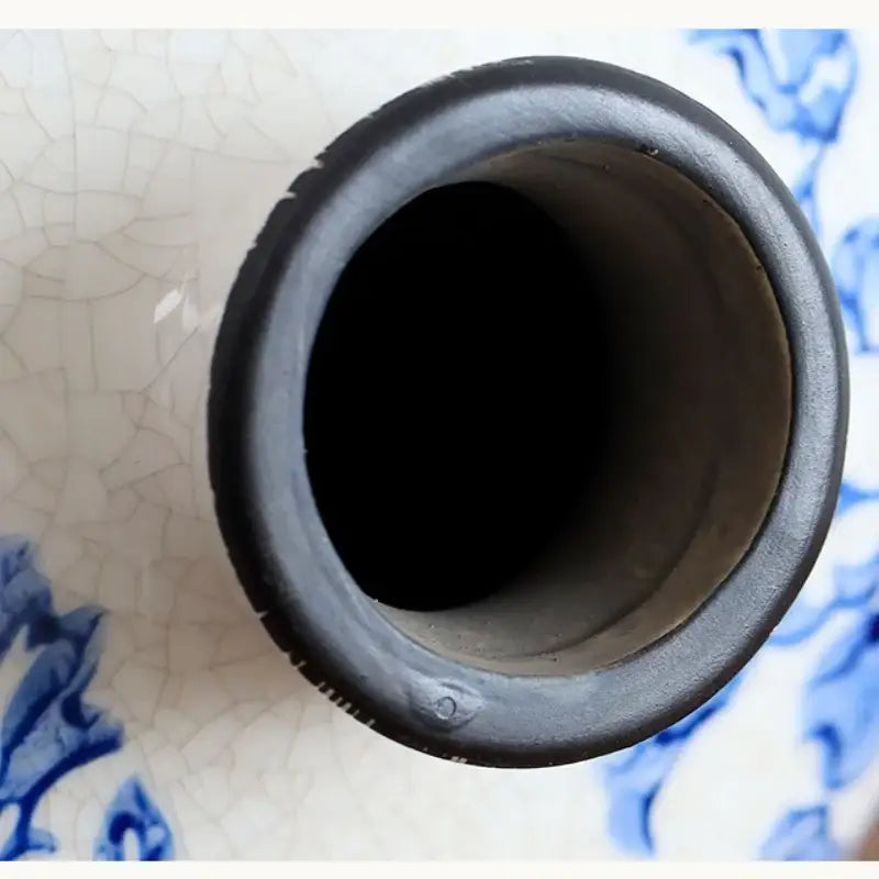 Black ceramic rim of white porcelain gourd teapot vase with crackled glaze and blue floral patterns for living room decor
