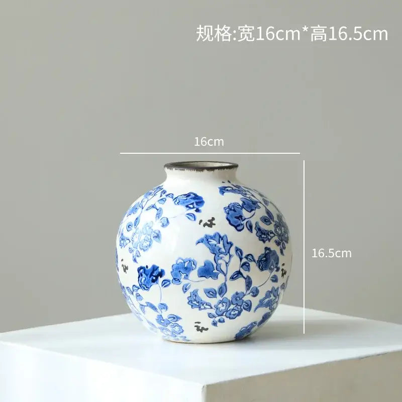 A round white porcelain gourd teapot vase with intricate blue floral patterns and a textured rim for living room decor