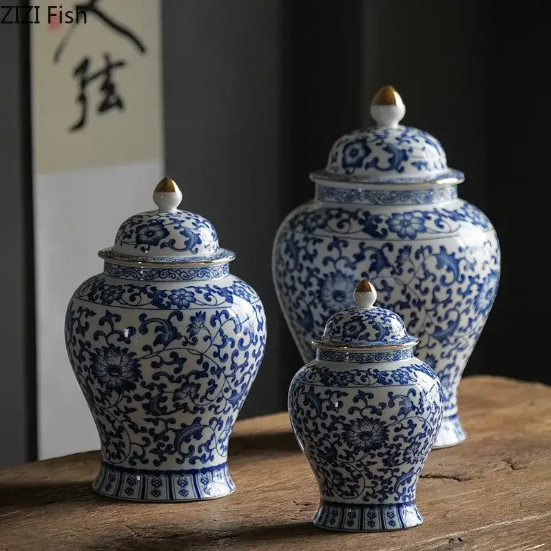 Three blue and white porcelain jars with intricate floral patterns and gold plating for living room decor