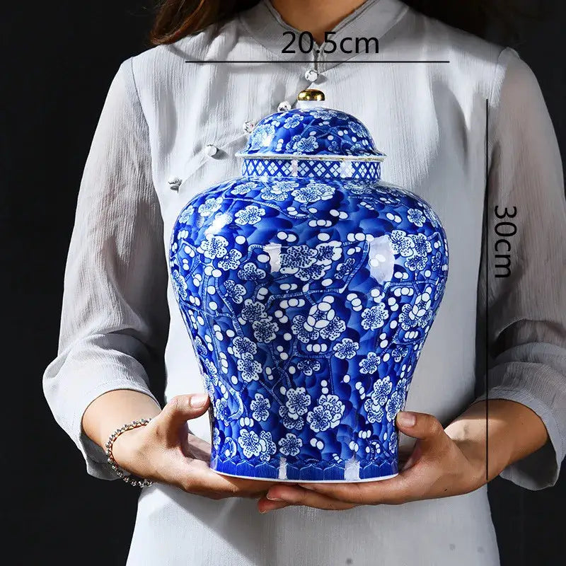 Blue and white porcelain ginger jar with intricate floral patterns and gold lid knob for sealed storage tank use