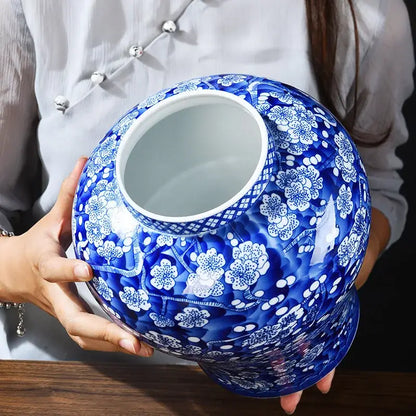 A glossy blue and white porcelain pot sealed storage tank with intricate floral patterns ideal for kitchen use
