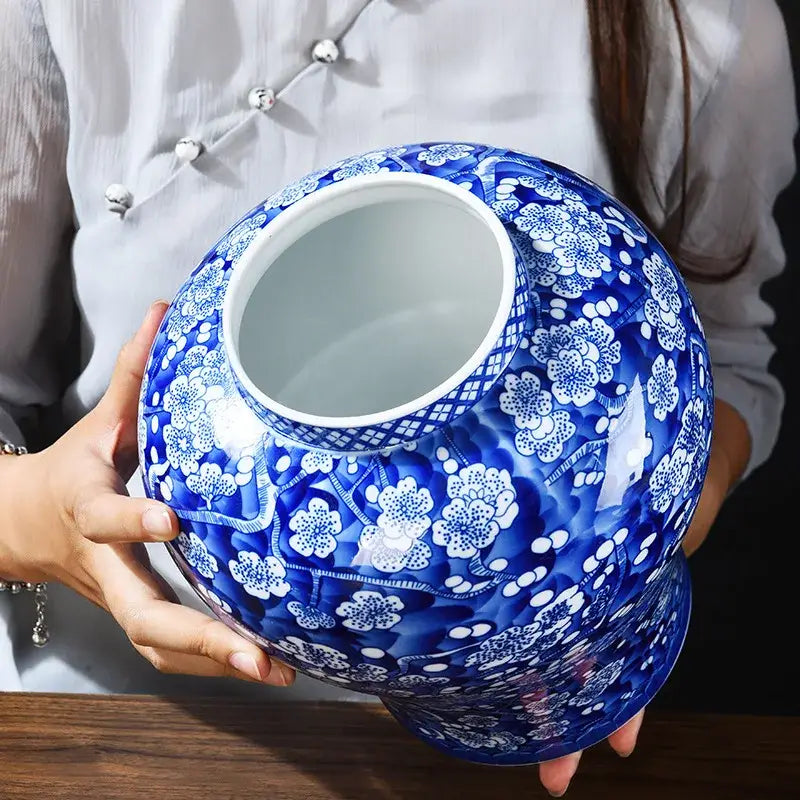 A glossy blue and white porcelain pot sealed storage tank with intricate floral patterns ideal for kitchen use