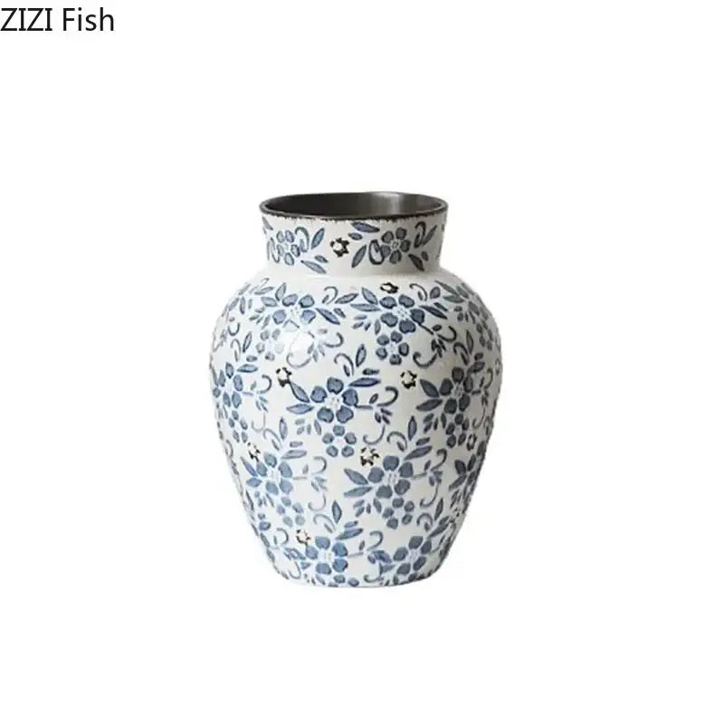 A white porcelain vase with delicate blue floral patterns and a metallic silver rim for hydroponic living room decorbites blue white porcelain