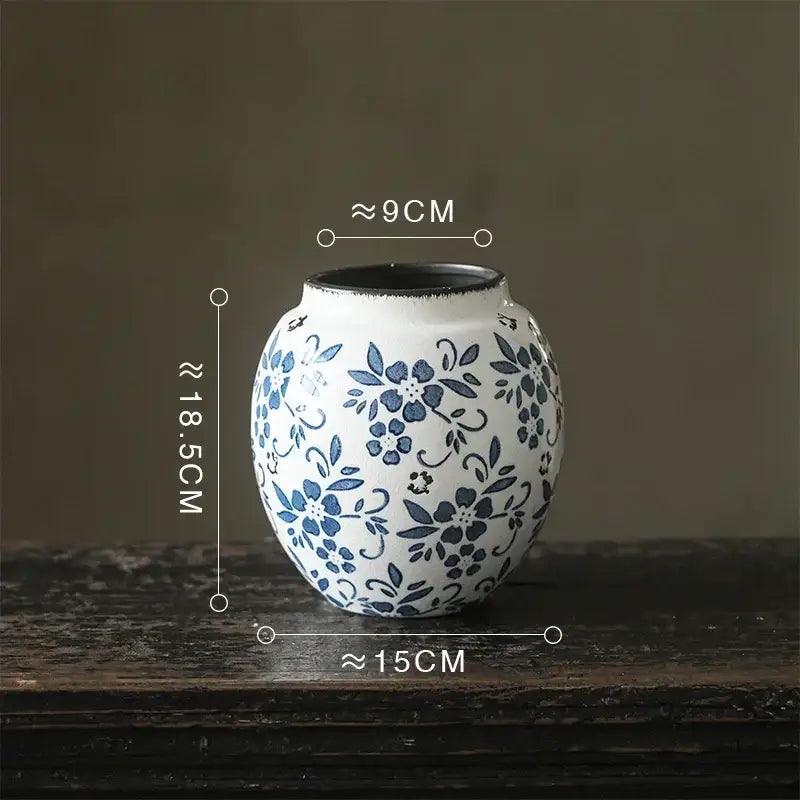 White porcelain vase with blue floral patterns black rim 18.5cm tall decorbites blue white porcelain pot