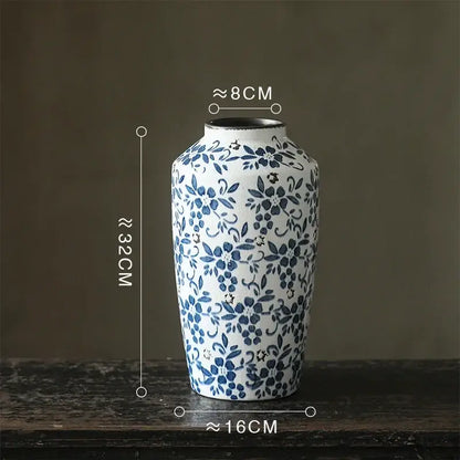 A white porcelain vase with blue floral patterns and a flared rim, perfect as decorbites blue white porcelain decor
