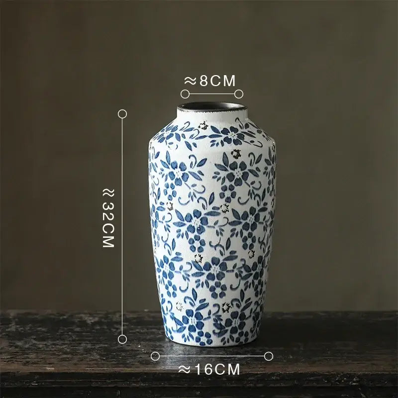 A white porcelain vase with blue floral patterns and a flared rim, perfect as decorbites blue white porcelain decor