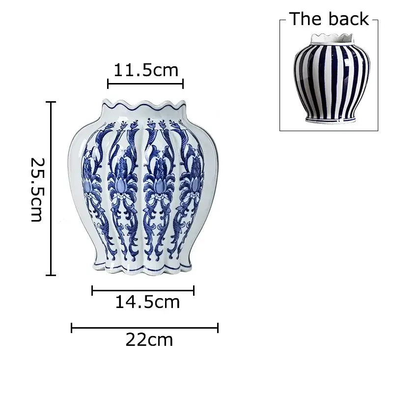 White porcelain vase with intricate blue floral patterns and scalloped rim showing vertical stripes on back for desk decor