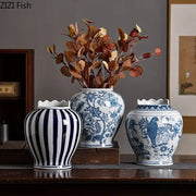 Three blue and white porcelain vases with artificial flowers featuring stripes floral and bird motifs for desk decor