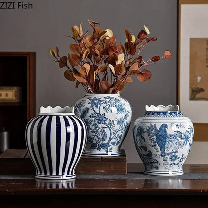Three blue and white porcelain vases with artificial flowers featuring stripes floral and bird motifs for desk decor