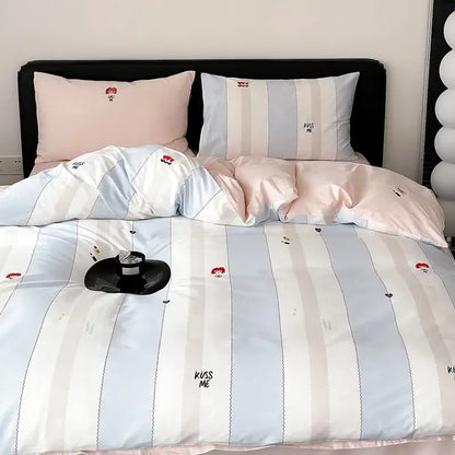 Pastel blue and white striped duvet cover set with embroidered kiss me text and small red cartoon faces for bedroom use