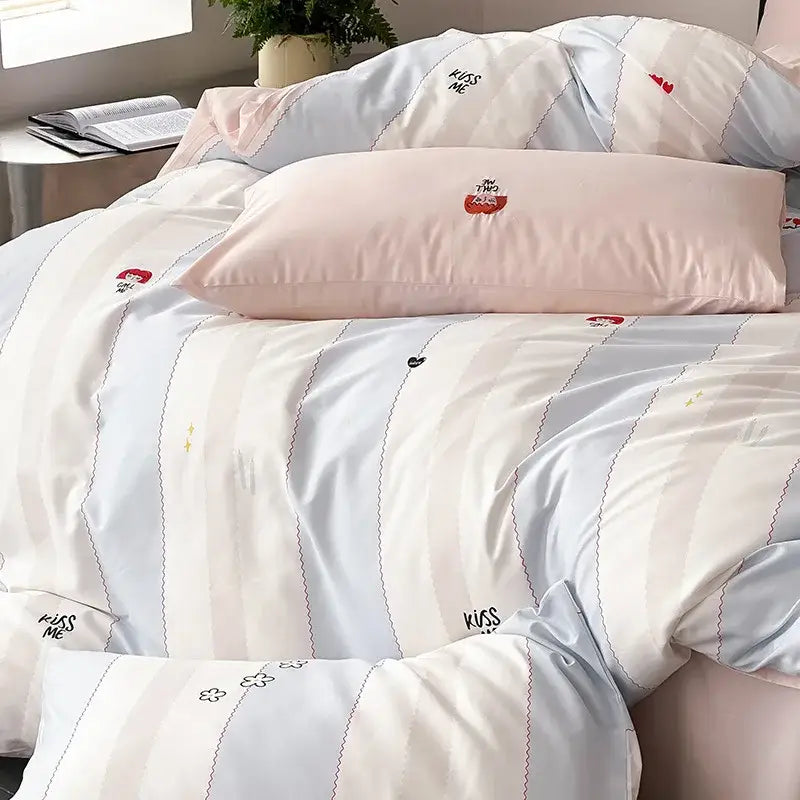 Pastel-striped duvet cover set in blue white with embroidered kiss me and cherry motifs in soft pink and light blue