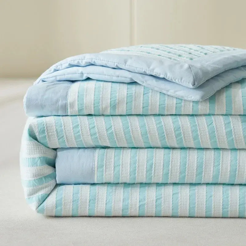 Stack of blue and white striped soya fibre decorbites jacquard summer quilts with soft quilted texture for bedroom comfort