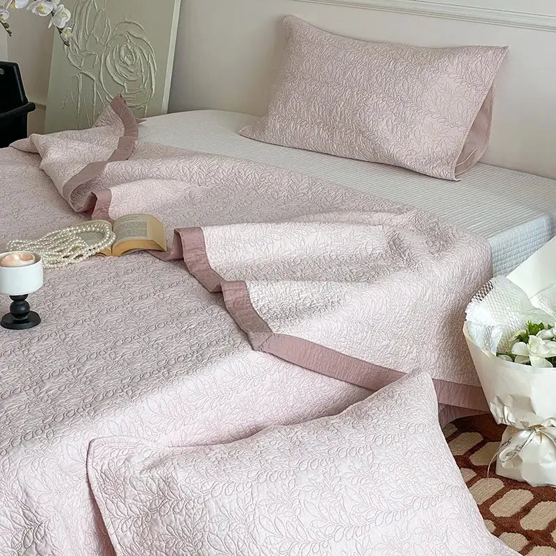 Blush pink decorbites cotton quilted bedspread set with delicate floral embroidery and contrasting mauve piping