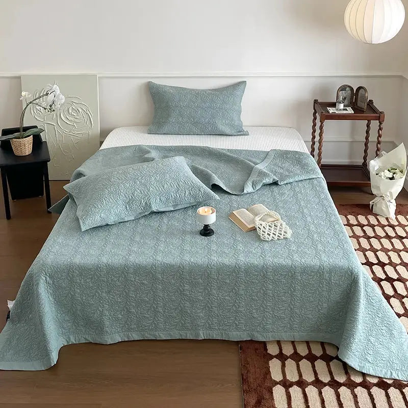 Light blue decorbites cotton quilted bedspread with subtle textured pattern in blush pink cotton quilted bedspread set