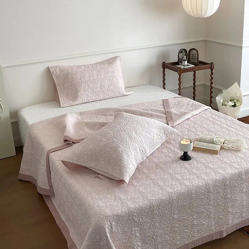 Soft blush pink cotton quilted bedspread set with subtle floral embroidery and matching pillowcase by decorbites
