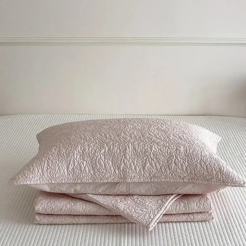 A blush pink cotton quilted bedspread set with a delicate leaf pattern for elegant bedroom decorbites cotton quilted use