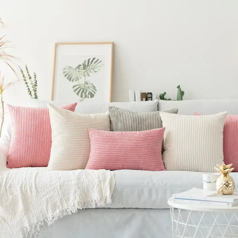 A collection of blush pink and cream corduroy flocking pillow covers on a light gray sofa for decorbites decorbites corduroy flocking