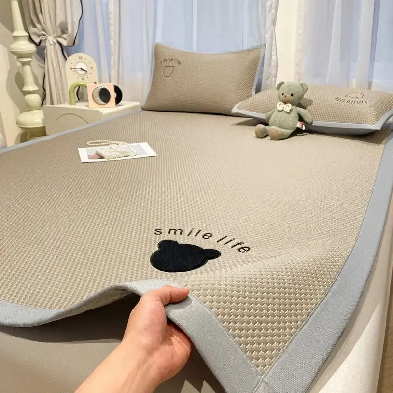 Beige textured cooling mattress pad with gray border and black bear design in blush pink diamond jacquard cooling bed sheet set