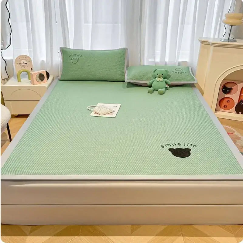 Mint green textured cooling mattress pad with black bear and smile life embroidery in blush pink cooling bed sheet set
