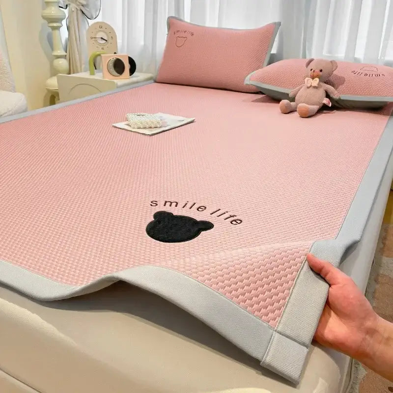 Blush pink diamond jacquard cooling bed sheet set with textured cooling mattress pad and black embroidered bear design